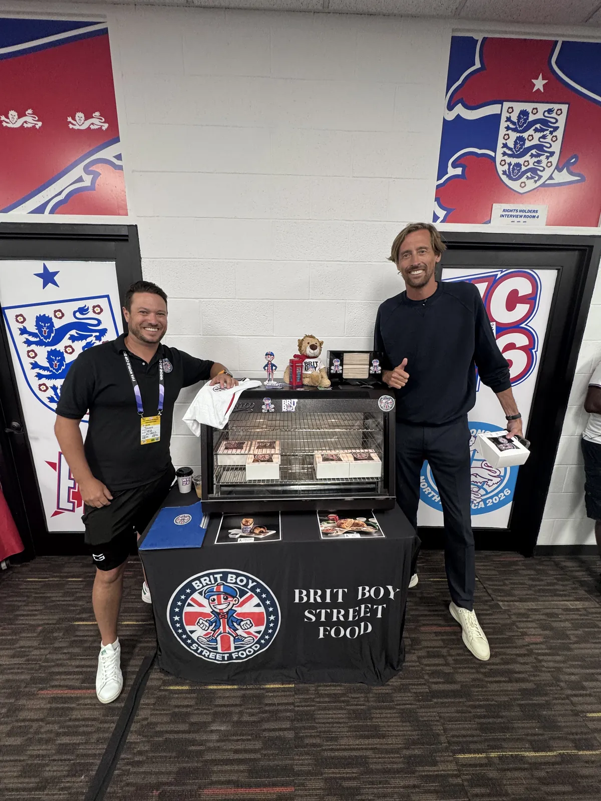 Chris Thomas and Peter Crouch at the Brit Boy stand inside the England camp