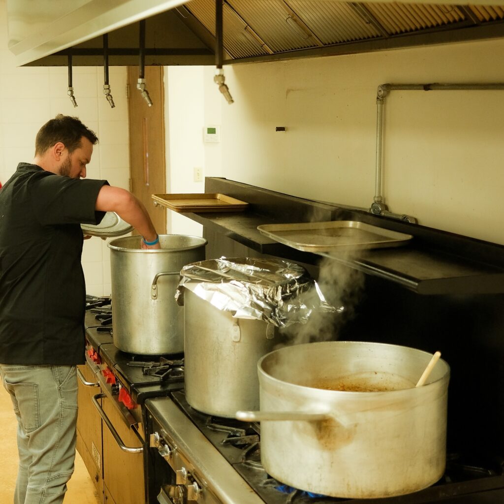Chris Thomas, owner of Brit Boy Street Food, cooking up pie fillings in some big pots