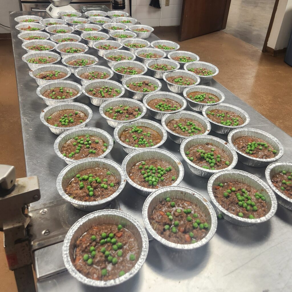 Lots of Shepherd's Pies ready to be packed and flash frozen in KC