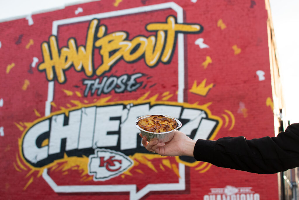 One of Brit Boy's potato mash topped pies in front of Kansas City Chiefs are in the Crossroads KC