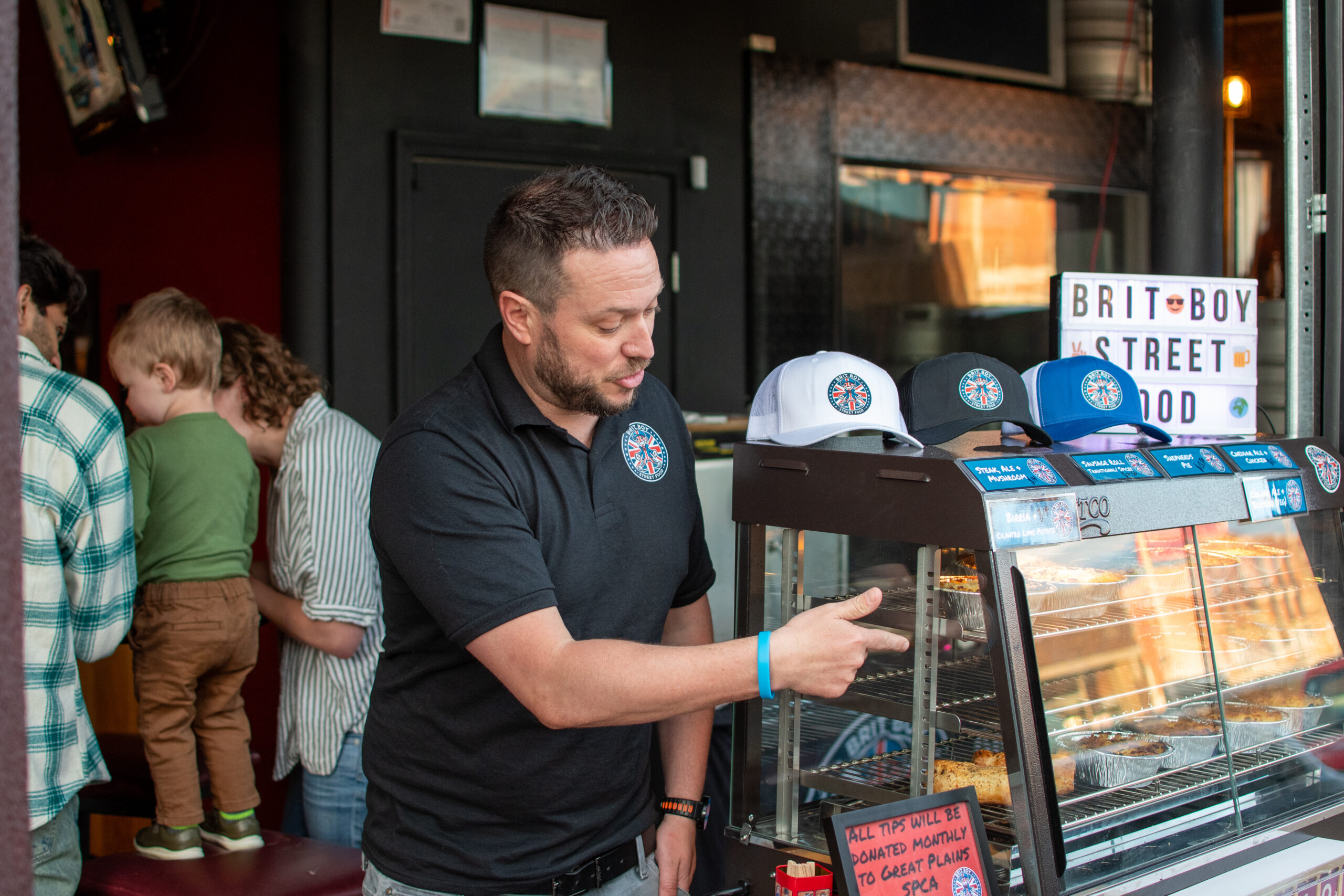 Owner of Brit Boy Street Food, Chris Thomas, proudly serving his customers outside a brewery pop up.