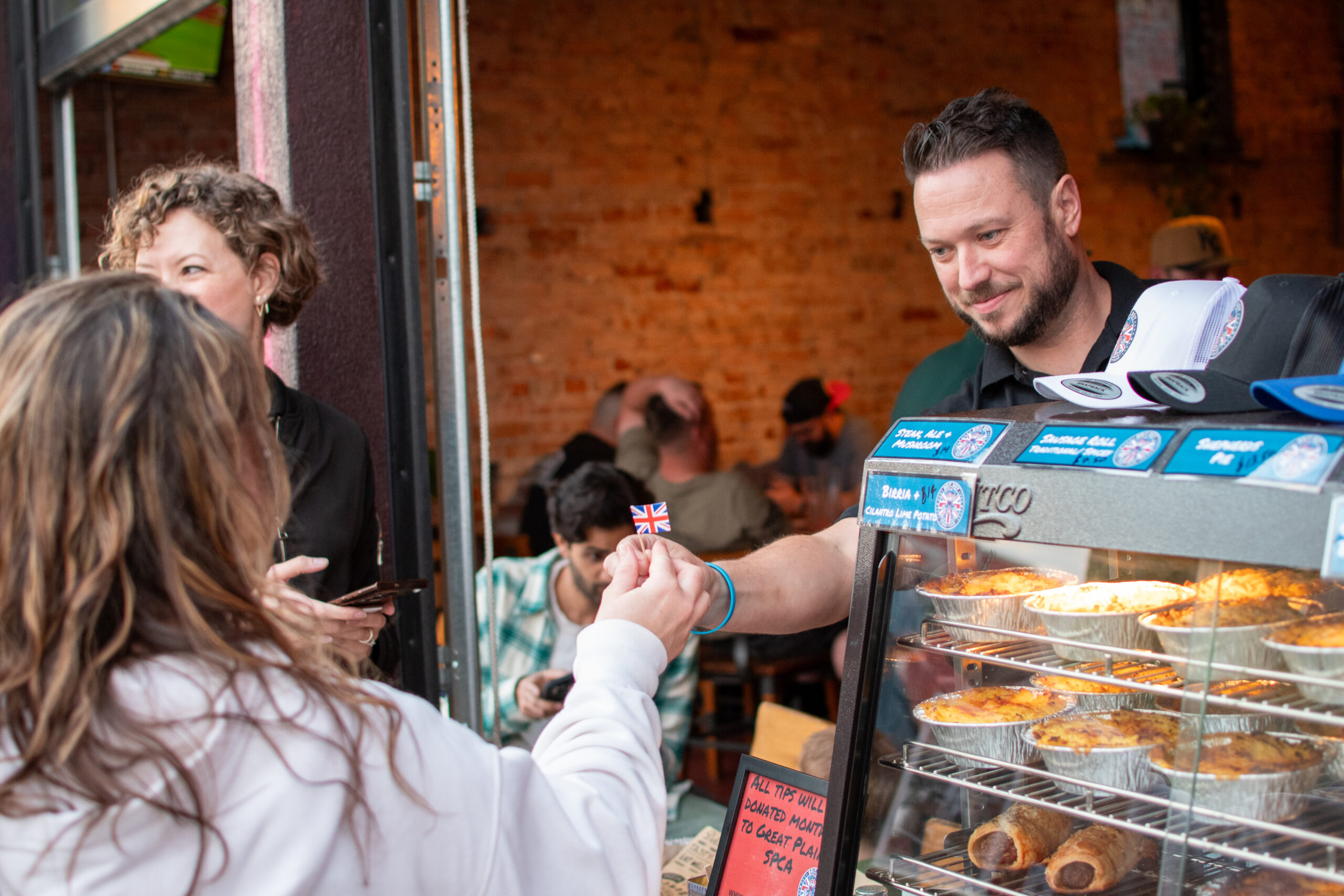Owner of Brit Boy Street Food, Chris Thomas, proudly serving his customers outside a brewery pop up.