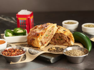 Spicy Sausage Roll by Brit Boy Street Food cut in half and staged with ingredients