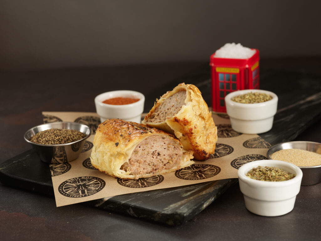 Traditional Sausage Roll by Brit Boy Street Food cut in half and staged with ingredients
