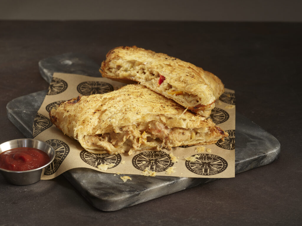 Cheddar Chicken Pasty Cut in Half with Lifestyle Background