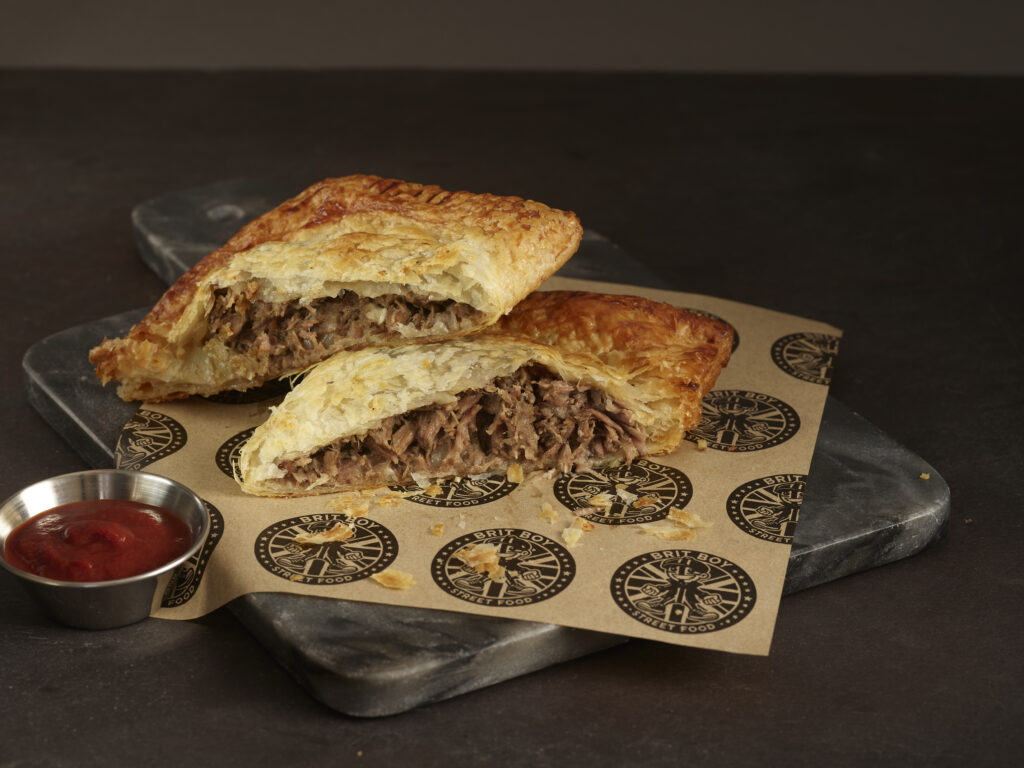 Steak Pasty cut in half with Lifestyle Background